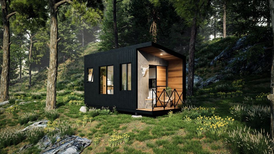 Rendering of the Nómada 0, a black tiny home with a wood-lined porch on a forested slope